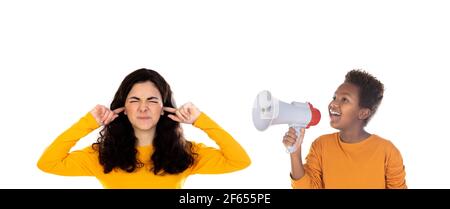 African child with a megaphone and a teenager girl covering her ears isolated on a white background Stock Photo