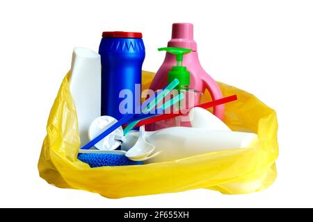 multi-colored empty plastic bottles and utensils in yellow trash bag, isolated on white background Stock Photo