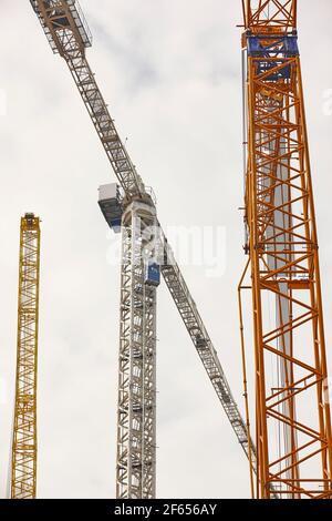 Telescopic cranes under a white sky. Construction engineering industry Stock Photo