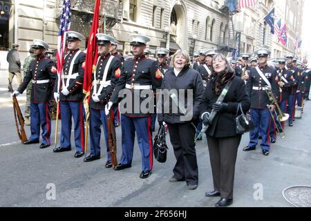 New York City, North America, St Patricks Day parade 17 March 2006. Two female tourist pose with soldiers in dress uniform on the street Stock Photo