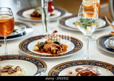 An assortment of dishes and desserts with drinks on a table Stock Photo
