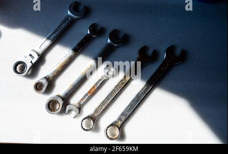 Old and rusty wrench tools on white countertop Stock Photo