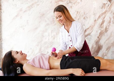 Professional masseur doing massage in the salon Stock Photo