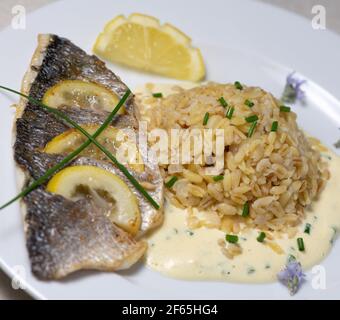 Lemon spiked sea bream fillet, cooked wheat risotto  Stock Photo