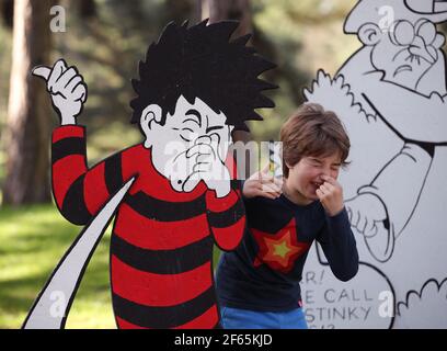 Children having fun with a giant 3D comic strip of the Beano, during the Easter festival at Kew Gardens in south-west London. This year's festival celebrates 70 years of Dennis the Menace with a series of activities and an interactive story trail around the gardens. Picture date: Tuesday March 30, 2021. Stock Photo