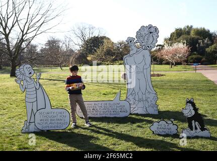 Children having fun with a giant 3D comic strip of the Beano, during the Easter festival at Kew Gardens in south-west London. This year's festival celebrates 70 years of Dennis the Menace with a series of activities and an interactive story trail around the gardens. Picture date: Tuesday March 30, 2021. Stock Photo