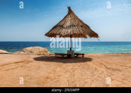 Parasol on coral beach in Red Sea, Egypt,  Africa. Stock Photo