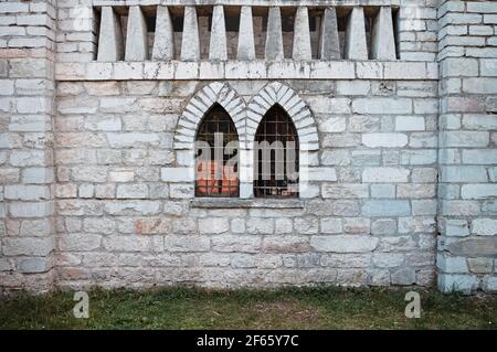 A mullioned window with pointed arches in a medieval stone building (Marche, Italy, Europe) Stock Photo