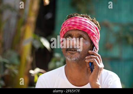 Indian farmer talking on mobile phone Stock Photo