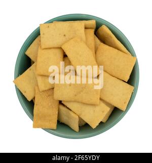 Top view Cheese and garlic snack crackers in a green bowl isolated on a white background. Stock Photo