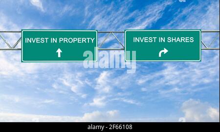 Road sign to investment in Share and property Stock Photo