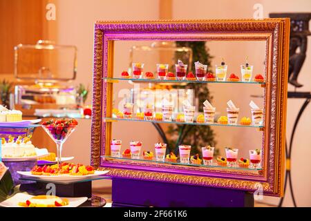 Table with various cookies, tarts, cakes, cupcakes and cakepops,Delicious sweets on candy buffet,Designed using picture frames. Stock Photo