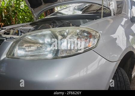 Car or Auto Headlight and Engine in Garage with Natural Light Stock Photo