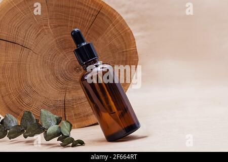Bottle with face serum and wooden saw cut Stock Photo