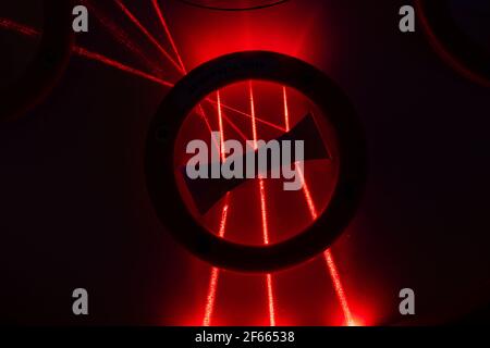 Dark street, reflection of neon light on wet asphalt. Rays of light and red laser light in the dark. Night view of the street, the city. Abstract dark Stock Photo