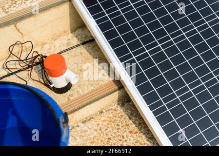 Testing bilge pump connected to use power from solar cell panel Stock Photo