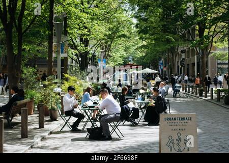 Marunouchi, Chiyoda, Tokyo, Japan - Office workers relaxing and having lunch at the urban terrace. Stock Photo