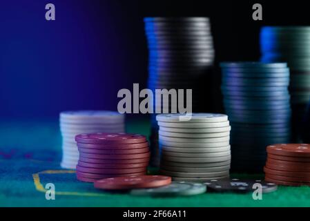Many multi-colored poker chips on the gaming table. Stock Photo