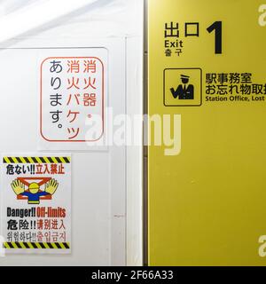 Tokyo, Japan - Warning sign in four different languages. Exit of subway station under repair. Stock Photo
