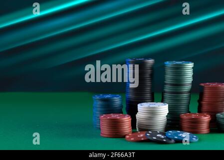 Many multi-colored poker chips on the gaming table. Stock Photo