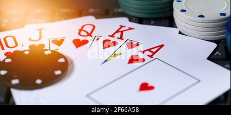 Game cards of the same suit against the background of casino chips. Stock Photo
