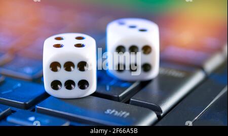 Online gaming platform, casino and gambling business. Bones on laptop keyboard. Stock Photo