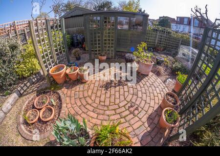 Suburban London garden comes to life under blue sky in warm spring weather on 30 March 2021 Stock Photo