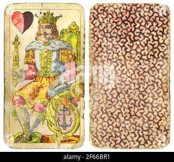 Vintage used antique playing card - king and heart - face and back - isolated on white with clipping path Stock Photo