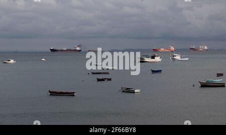 salvador, bahia / brazil - may 13, 2014: fishing vessels and cargo ships are seen in Bahia de Todos os Santos in the city of Salvador.   *** Local Cap Stock Photo