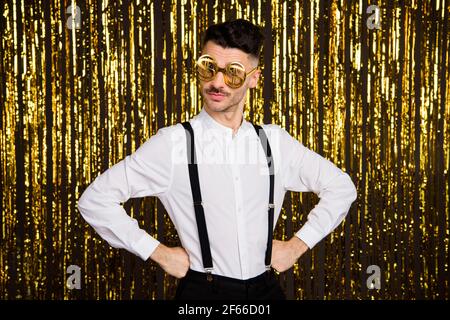 Young Handsome Macho in Formal Wear with Suspenders and in Glass