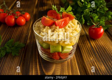 Vegetarian salad with vegetables and quinoa on the brown wooden  background Stock Photo