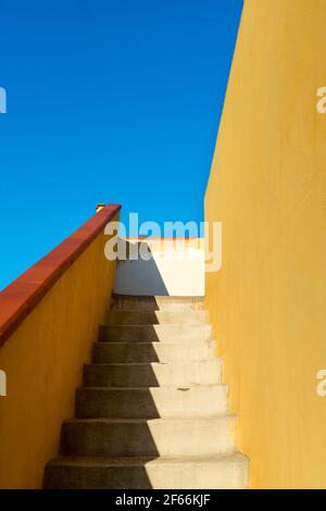 Stairway outdoor with sunlight and diagonal shadow on hot day in Sicily Stock Photo