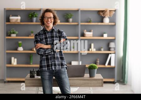Happy Freelancer Hipster Guy Standing Posing In Modern Office Stock Photo