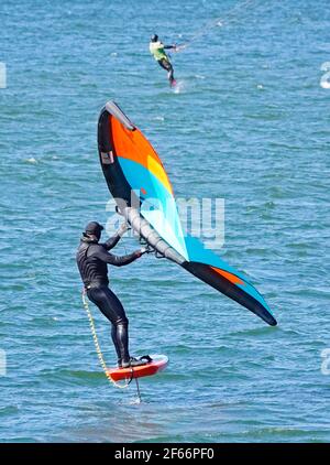 A man sailing on the Columbia River in the Columbia River Gorge near Hood River, Oregon, on a Wing Foil, or Sling Wing, or Slingshot, board. Stock Photo