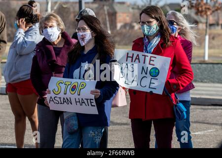 Maple Grove, Minnesota. March 25, 2021. Masked protesters at a stop Asian hate rally to remember the victims of the Atlanta Killings. Stock Photo