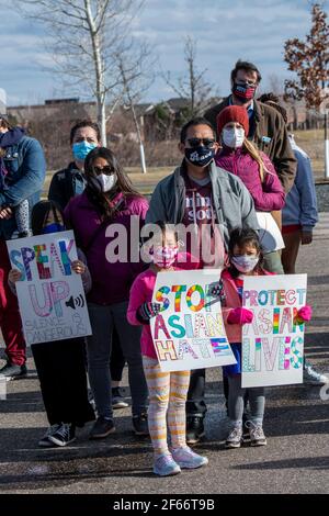 Maple Grove, Minnesota. March 25, 2021. An Asian family at a protest to stop Asian hate and to remember the victims of the Atlanta Killings. Stock Photo