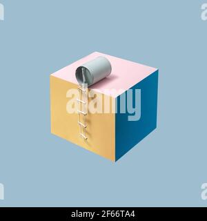 Pastel blue bean can with attached pilot ladder placed on pink, blue and yellow cube in front of a blue background. Minimalist concept, isometric Stock Photo