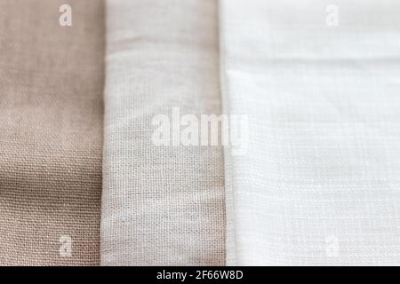 Textural background of three types of natural linen fabric. Selective focus. Closeup view Stock Photo