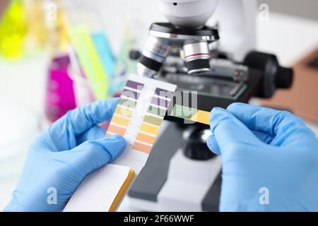 Scientist chemist holding ph test in his hands closeup Stock Photo