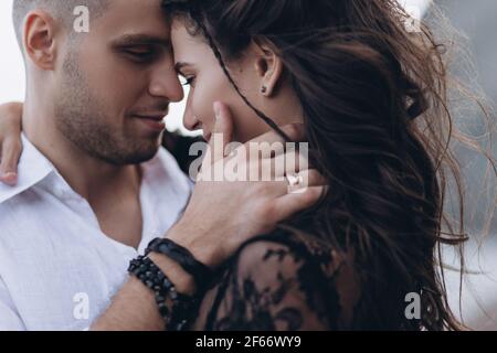 Wedding couple in love in boho style. Asymmetric bouquet of roses. Stock Photo