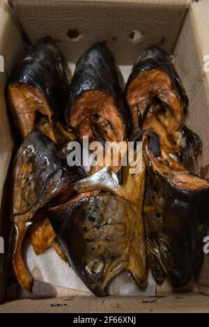 Smoked fish in craft paper box. Ready for delivery production. Smoked fish production concept