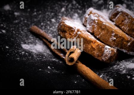 cupcake cookies with cinnamon sticks on a black background with sugar powder Stock Photo