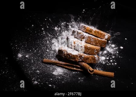 cupcake cookies with cinnamon sticks on a black background with sugar powder Stock Photo