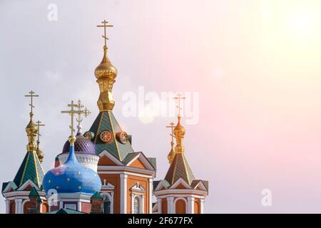 Russian Christian Orthodox church with domes and a cross against the sky. Russian Orthodoxy and Christian Faith concept. High quality photo Stock Photo