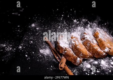 cupcake cookies with cinnamon sticks on a black background with sugar powder Stock Photo