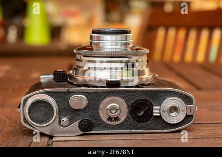Old analog camera from bottom up and black leather case Stock Photo