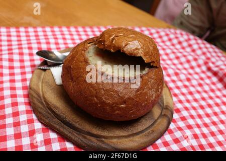 Goulash served in bread pot at czech restaurant Stock Photo