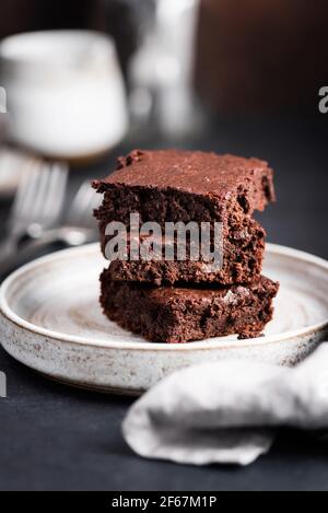 Stack of chocolate brownies on a plate. Chocolate cake square pieces brownies Stock Photo