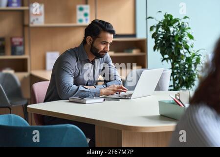 Indian business man student working or studying on laptop computer. Stock Photo