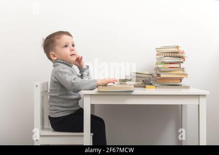 Closeup of cute small boy reading books Stock Photo